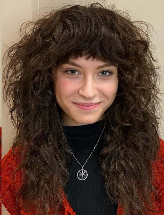 Layered Wolf Cut with Thick Bangs on Wavy Hair