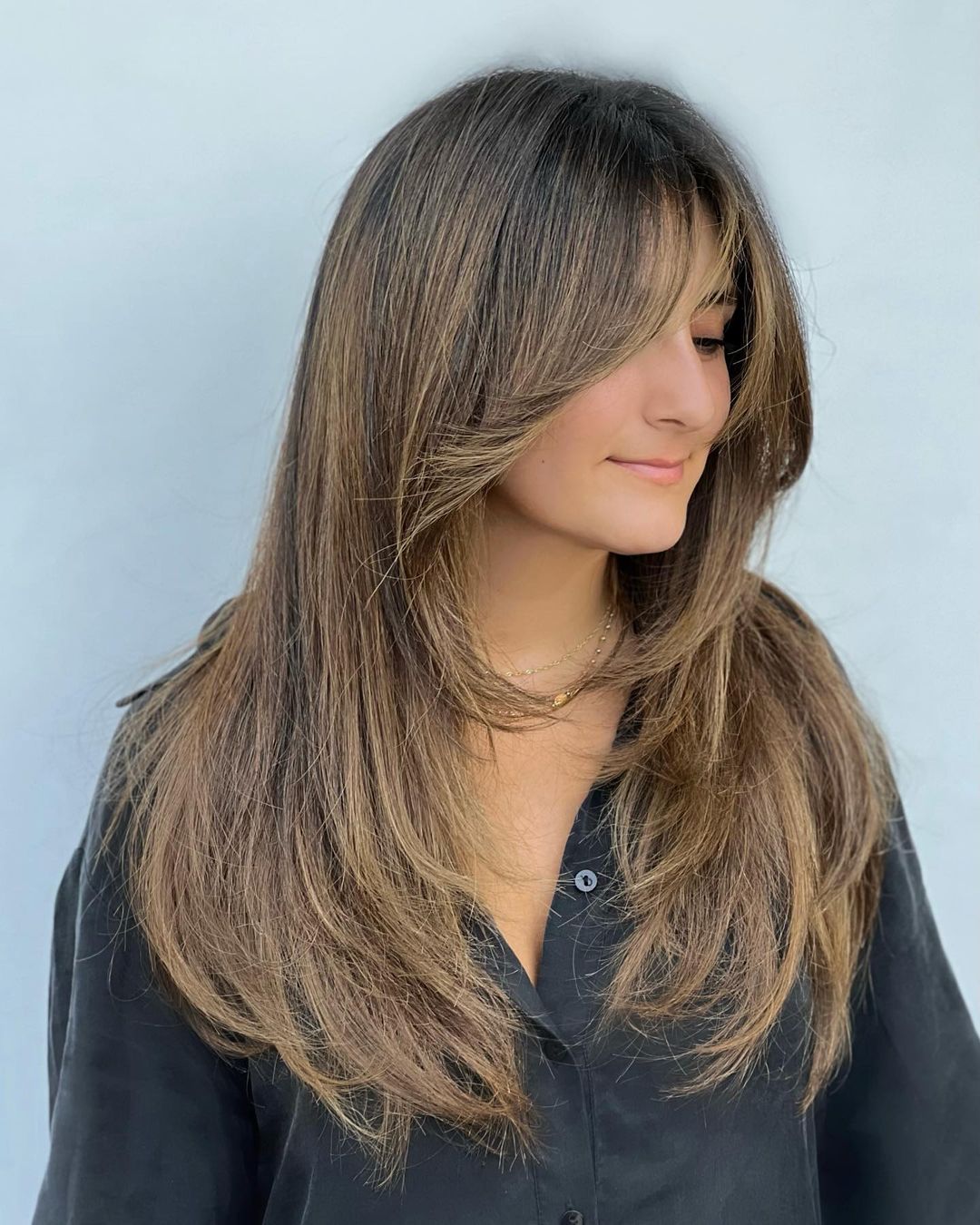 Long Feathered Haircut with Chin Length Framing Bangs
